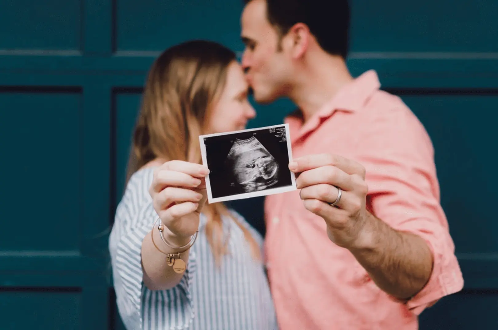 An expecting couple showing a sonogram